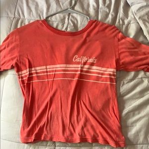 a light red, short sleeve brandy melville shirt